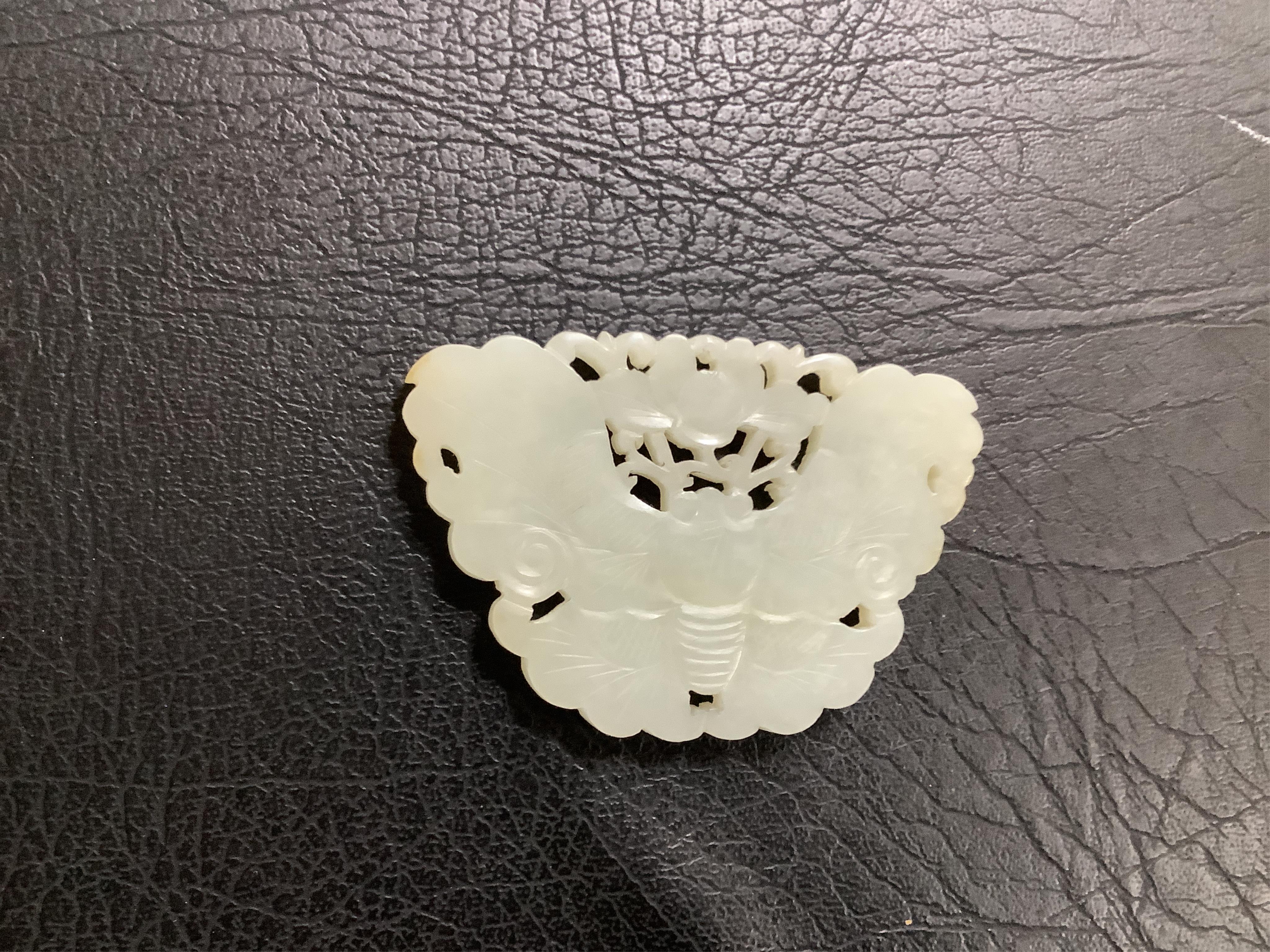 A Chinese reticulated jade ‘butterfly’ plaque , late Qing dynasty, 7cm wide. Condition - good